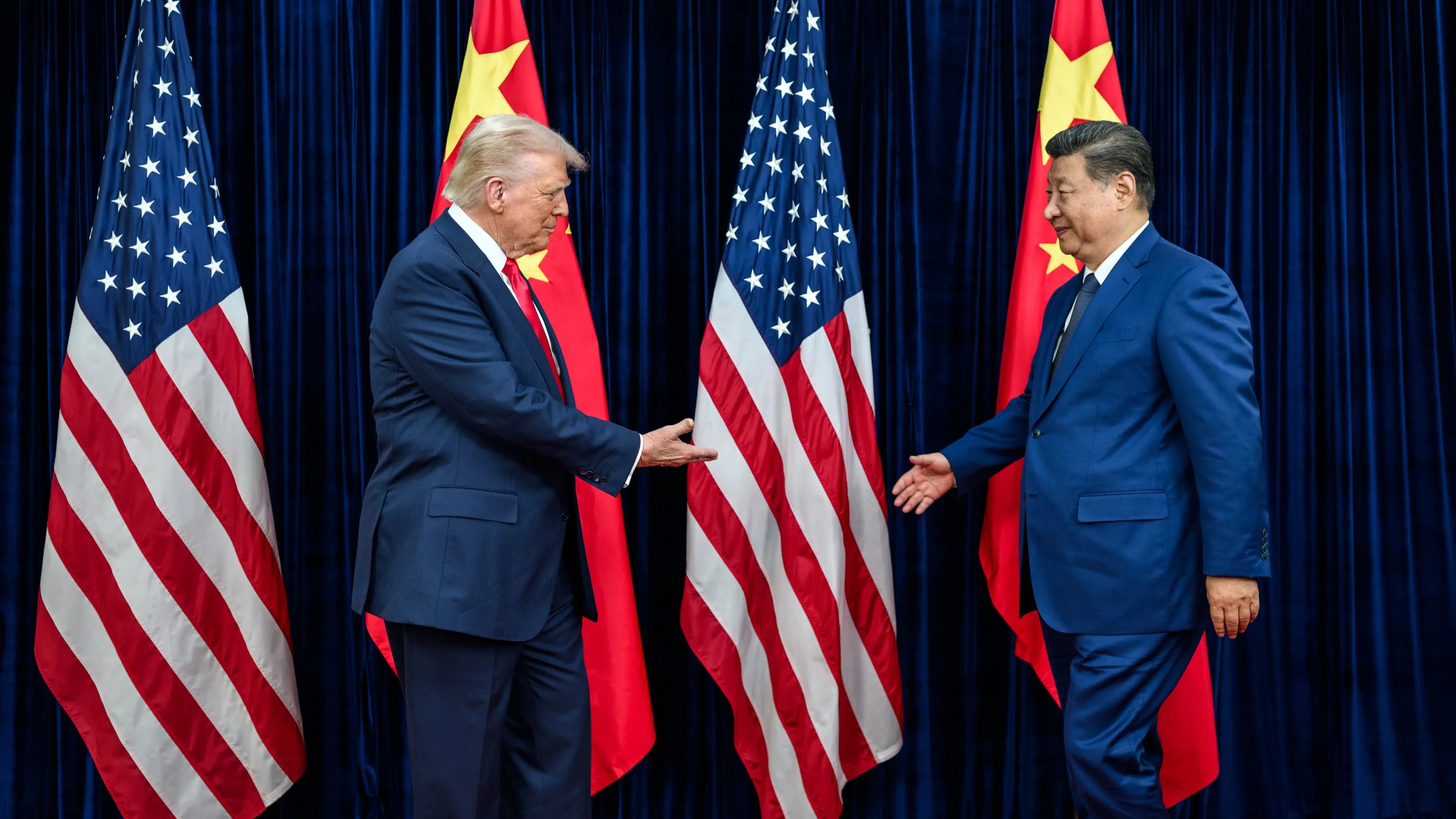 Donald Trump and Xi Jinping shaking hands in front of American and Chinese flags. Credit photo: White House