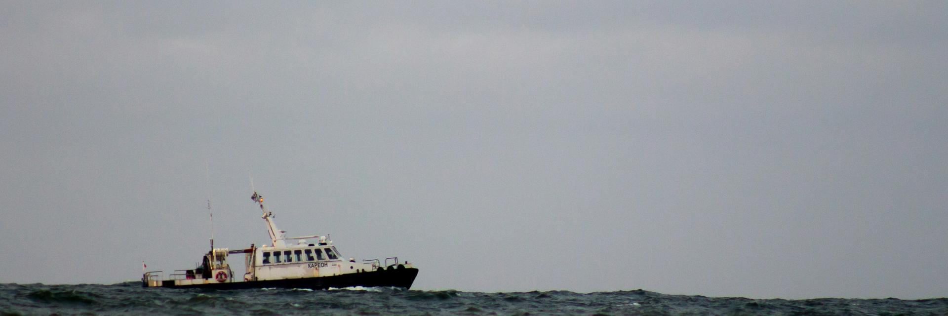 White boat on the sea. Credit: Photo by Aleksey Malinovski on Unsplash