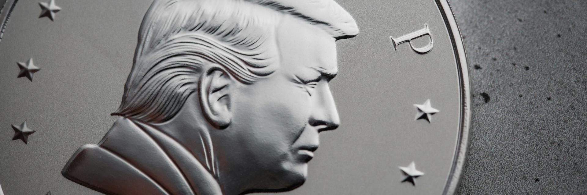 Close-up of a silver coin with a picture of President Trump. Credit: Photo by Scottsdale Mint on Unsplash