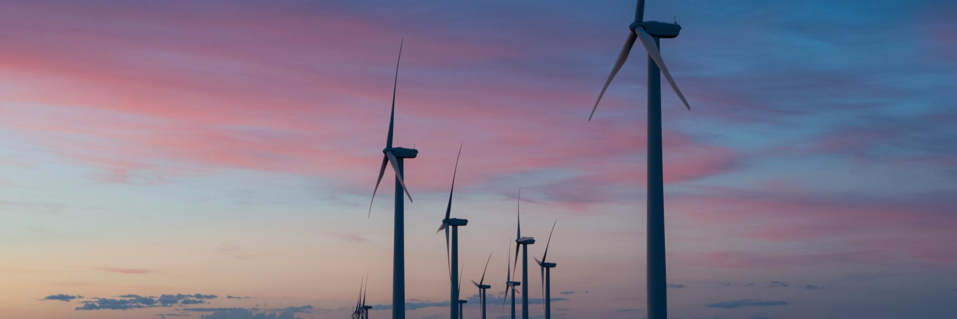 A wind farm at dusk | © Unsplash, Dan Meyers