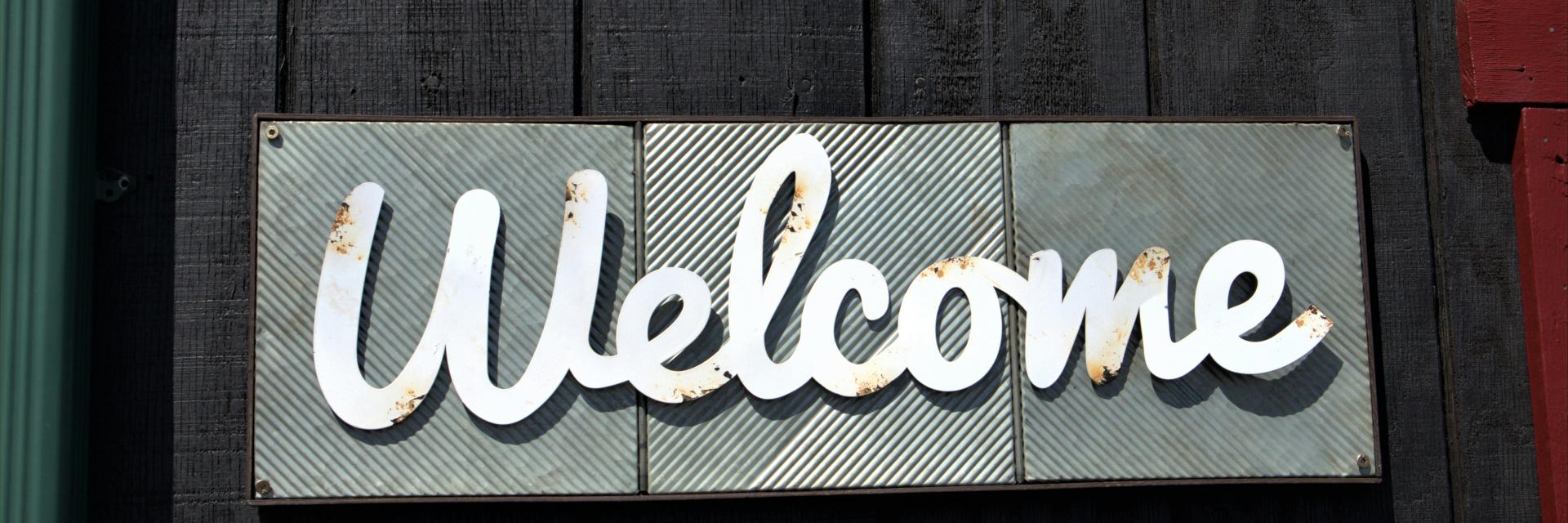 Welcome sign. Credit: Photo by Katherine Hood on Unsplash 