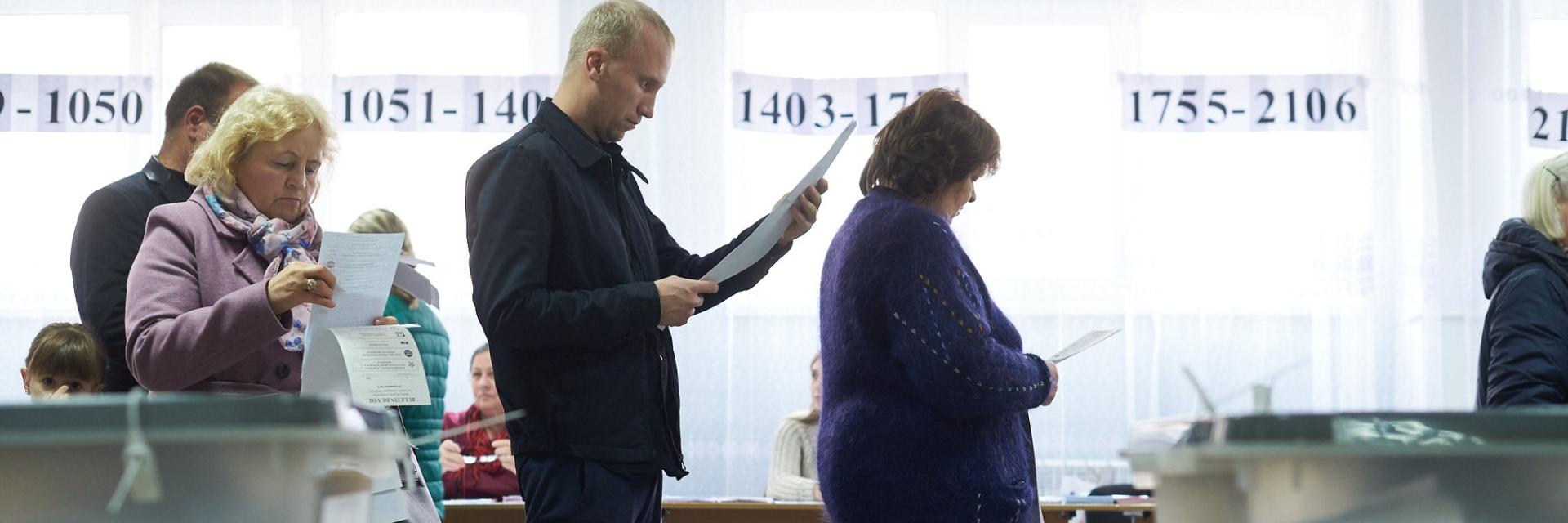 People standing in polling station in Moldova. Credit: Sandro Weltin/©Council of Europe. Some right reserved