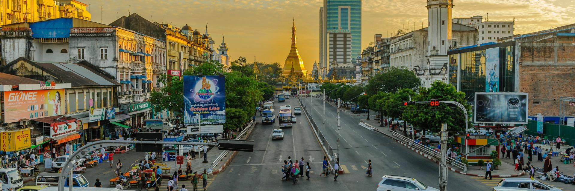 People walking on pedestrian lane during daytime in Yangon. Photo by Alexander Schimmeck on Unsplash