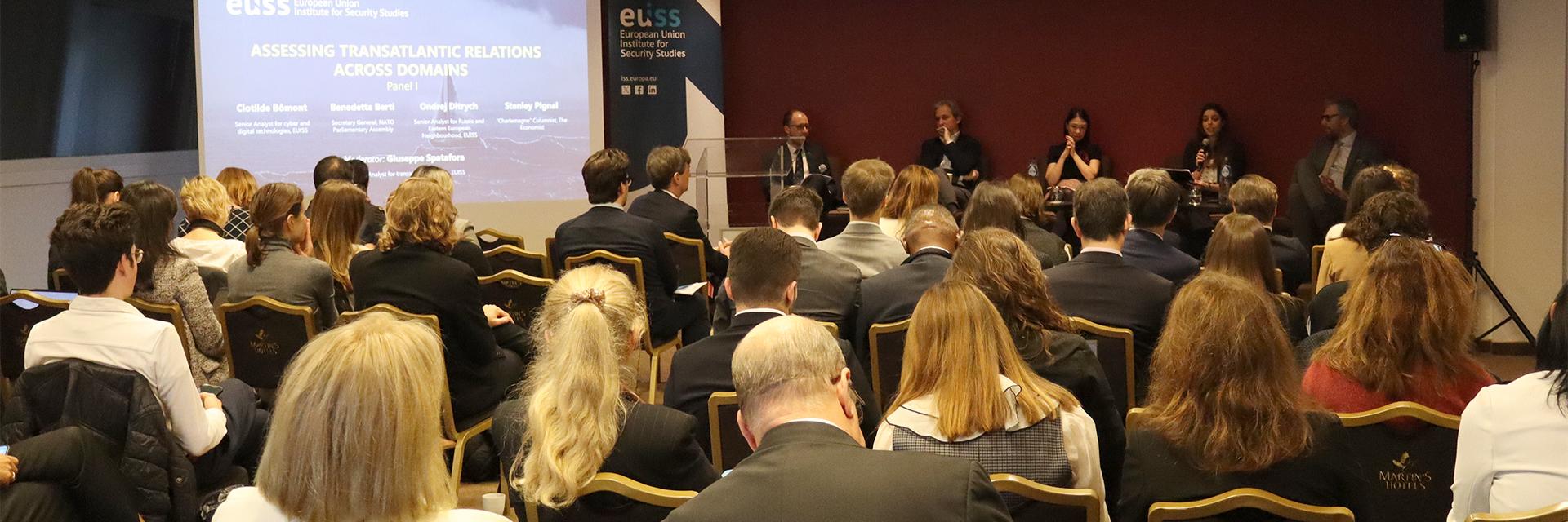 Room full of participants looking at stage where the speakers are sitting. Photo credit: EUISS 