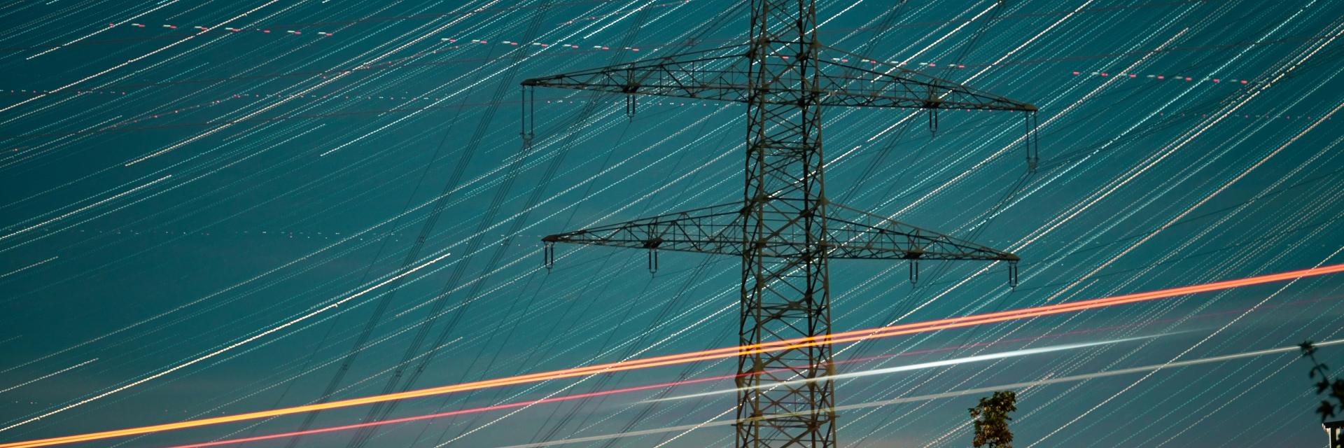 A high voltage power line at night with long exposure. Photo by Viva Zhang on Unsplash