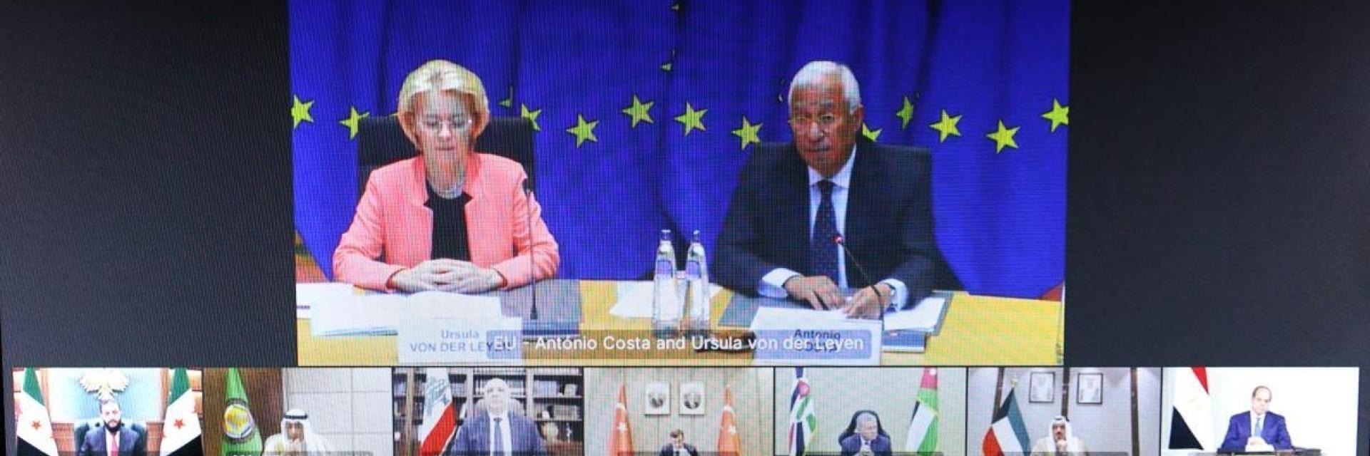 Video conference screen showing Ursula von der Leyen and Antonio Costa sitting at a table in front of EU flag, and multiple smaller windows below displaying participants from various Middle Eastern countries joining remotely