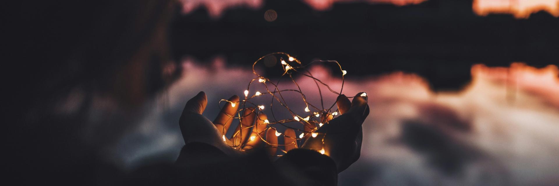  Person holding turned on string lights during nighttime Photo by Natalya Letunova on Unsplash