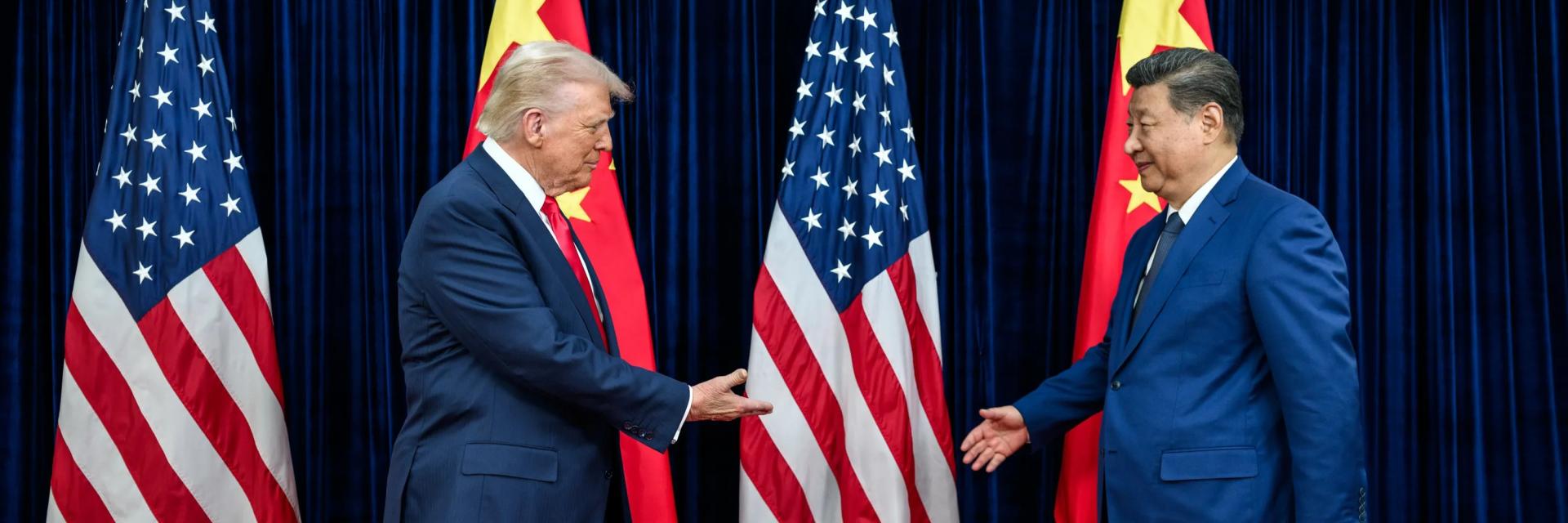 Donald Trump and Xi Jinping shaking hands in front of American and Chinese flags. Credit photo: White House
