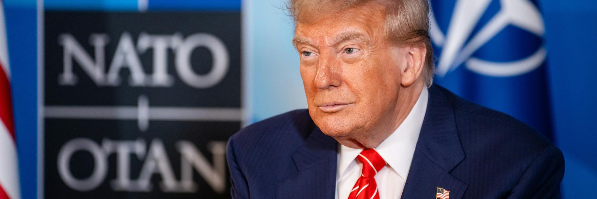 Donald Trump with NATO logo in the background. Credit photo: NATO
