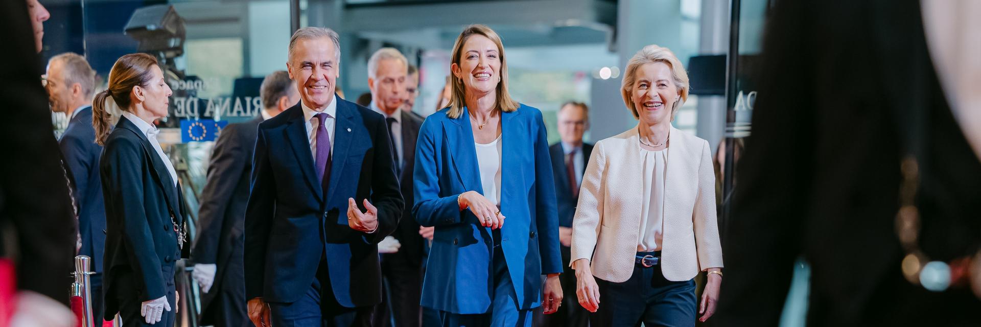 Mark Carney walking next to Roberta Metsola and Ursula von der Leyen. European Union, 2026.