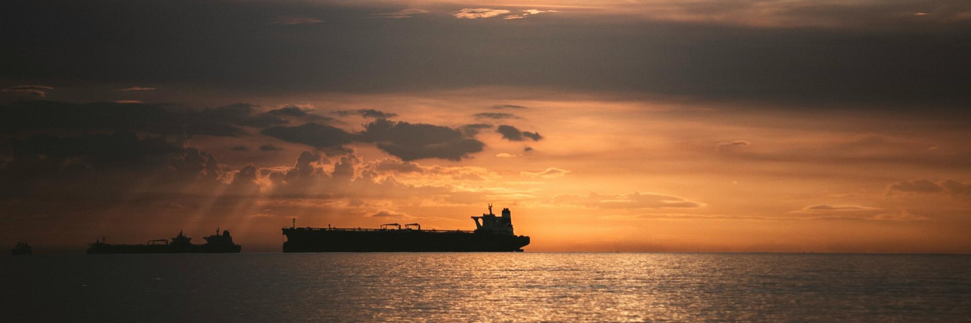 A ship sails into the sunset. Photo by alejandro luna on Unsplash