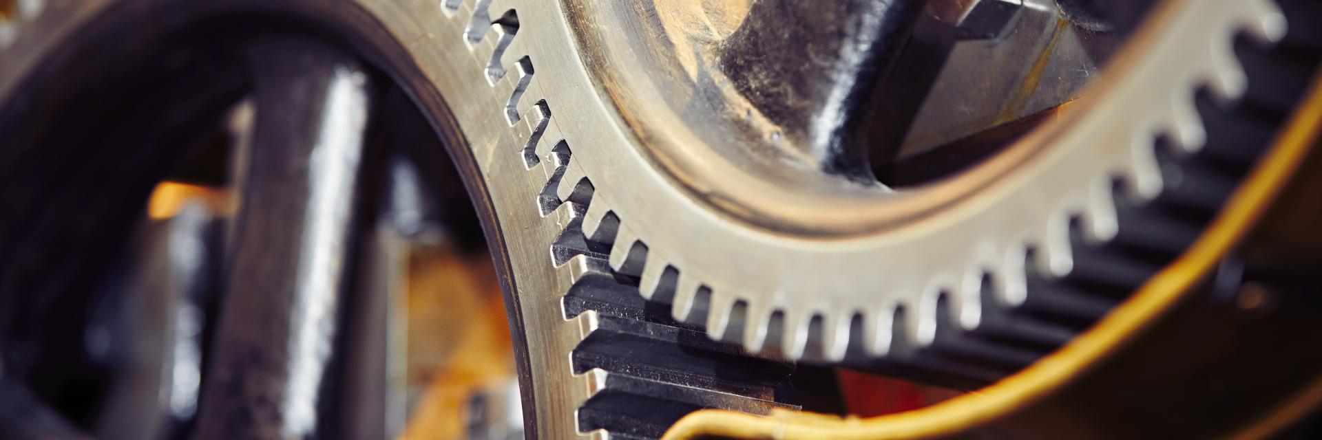 Extreme close-up of interlocking industrial gears. Image credit to Envato Elements.