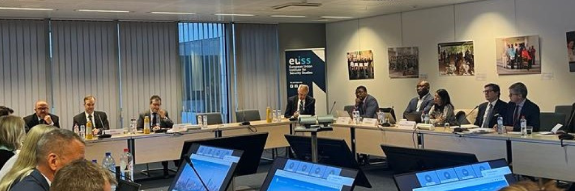 Participants to the seminar sitting around a table with screens © EUISS