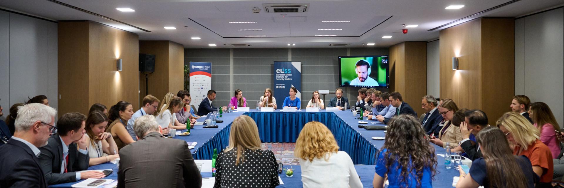 Participants to the event sitting around a table ©GLOBSEC