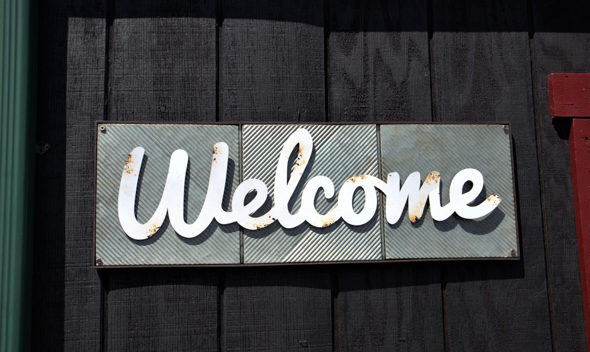 Board with "Welcome" written on it. Photo by Katherine Hood on Unsplash 