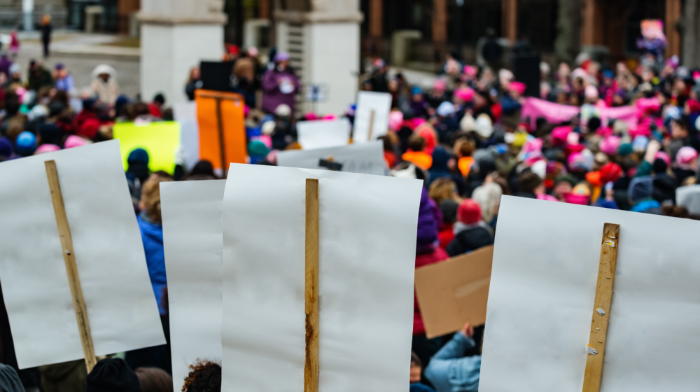 People protesting credit: Canva