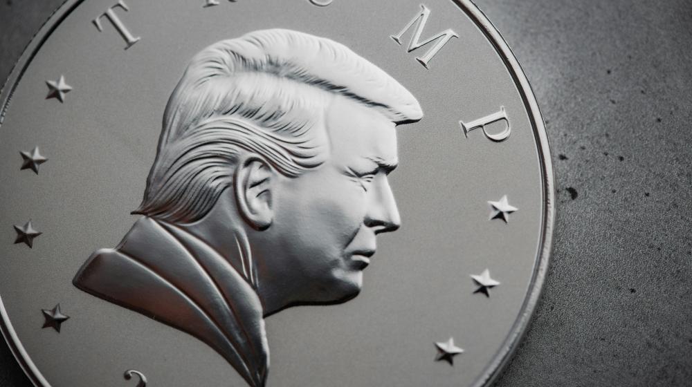Close-up of a silver coin with a picture of President Trump. Credit: Photo by Scottsdale Mint on Unsplash
