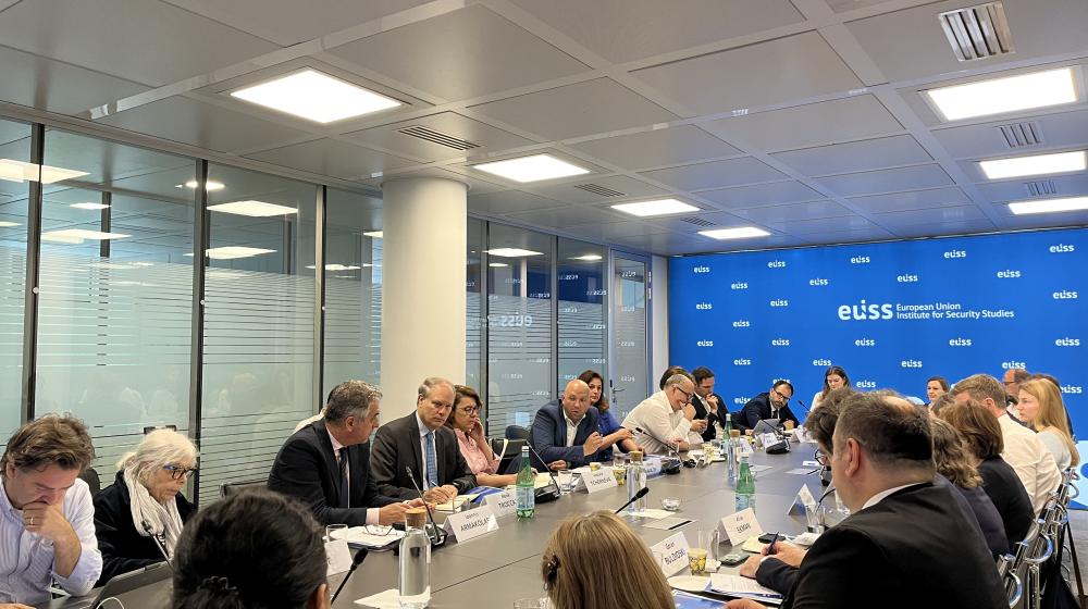 Participants to seminar sitting around a table © EUISS