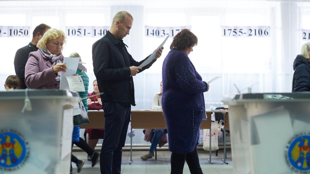 People standing in polling station in Moldova. Credit: Sandro Weltin/©Council of Europe. Some right reserved