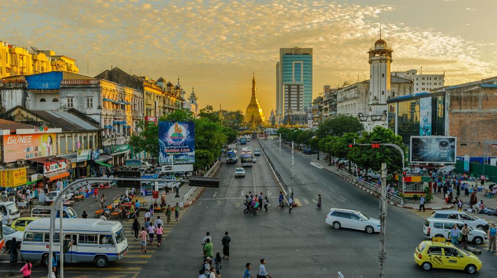 People walking on pedestrian lane during daytime in Yangon. Photo by Alexander Schimmeck on Unsplash