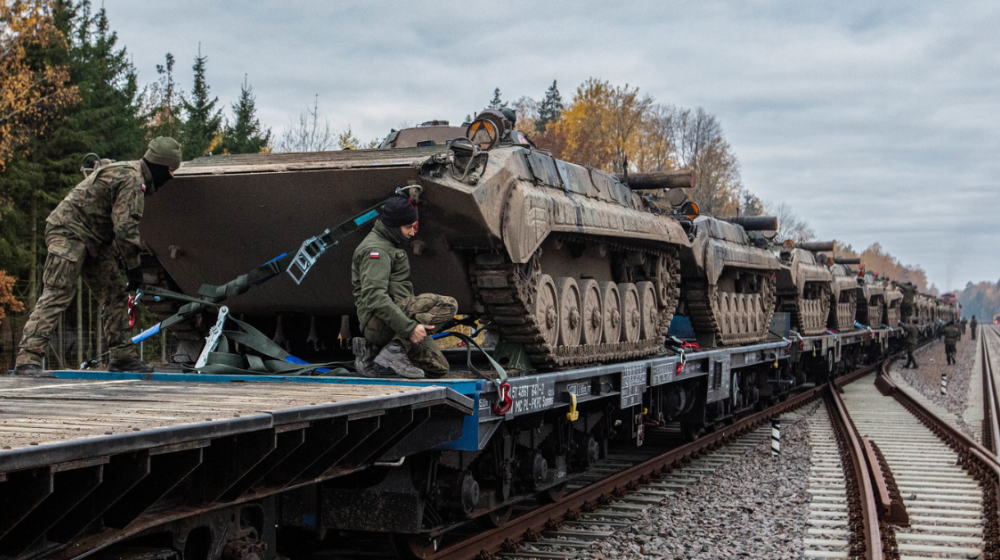 Soldiers on tanks. Credit: NATO/Flickr 