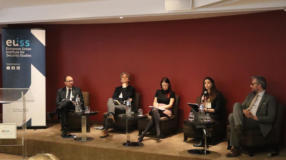 Speakers sitting on stage. Credit photo: EUISS