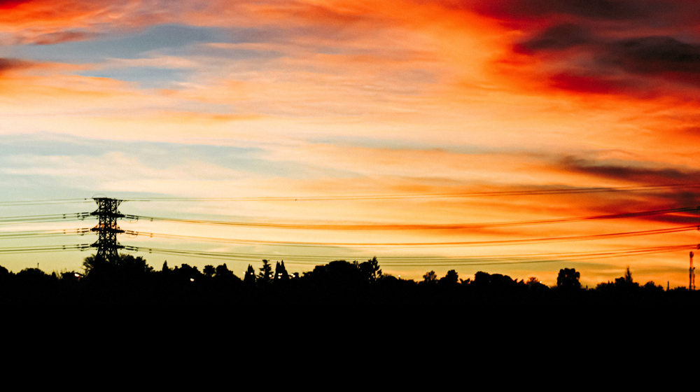Sunset sky and power lines in South Africa | Credit: Roderick Laka on Unsplash 