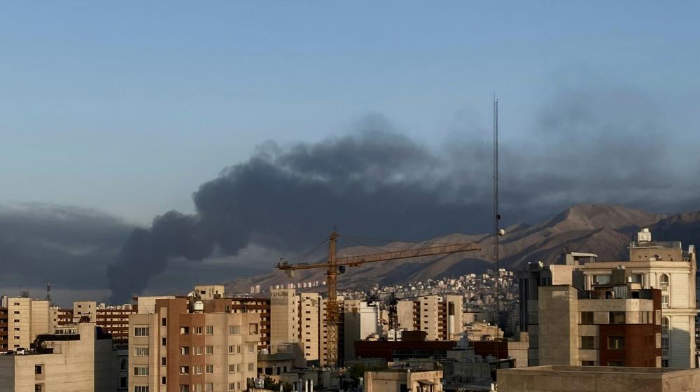 View of Teheran with smoke over buildings. Credit photo: Photo by sadaf vakilzadeh on Unsplash