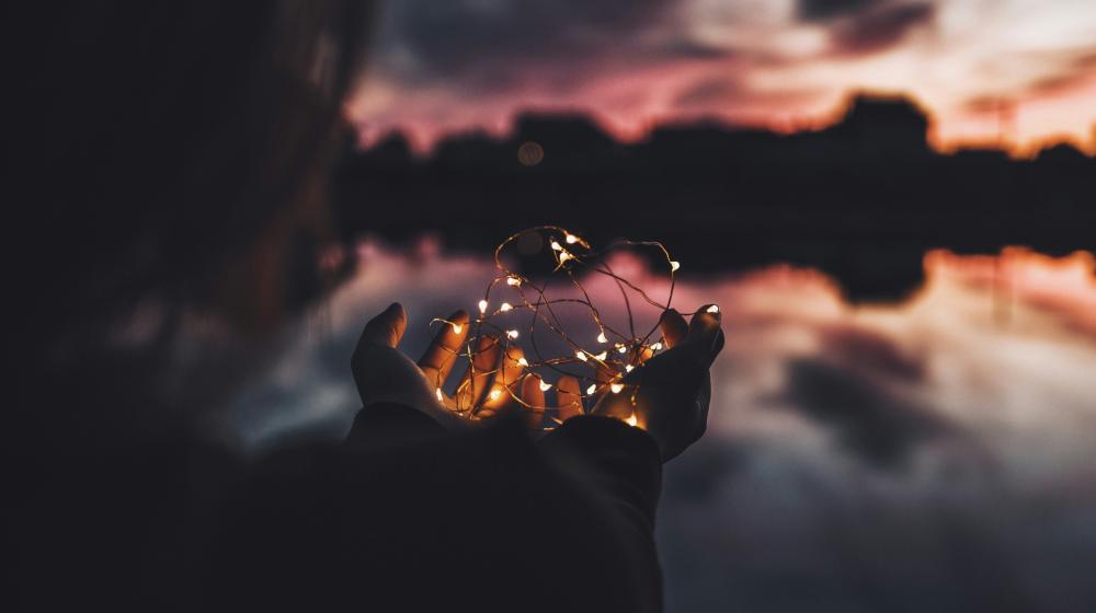  Person holding turned on string lights during nighttime Photo by Natalya Letunova on Unsplash