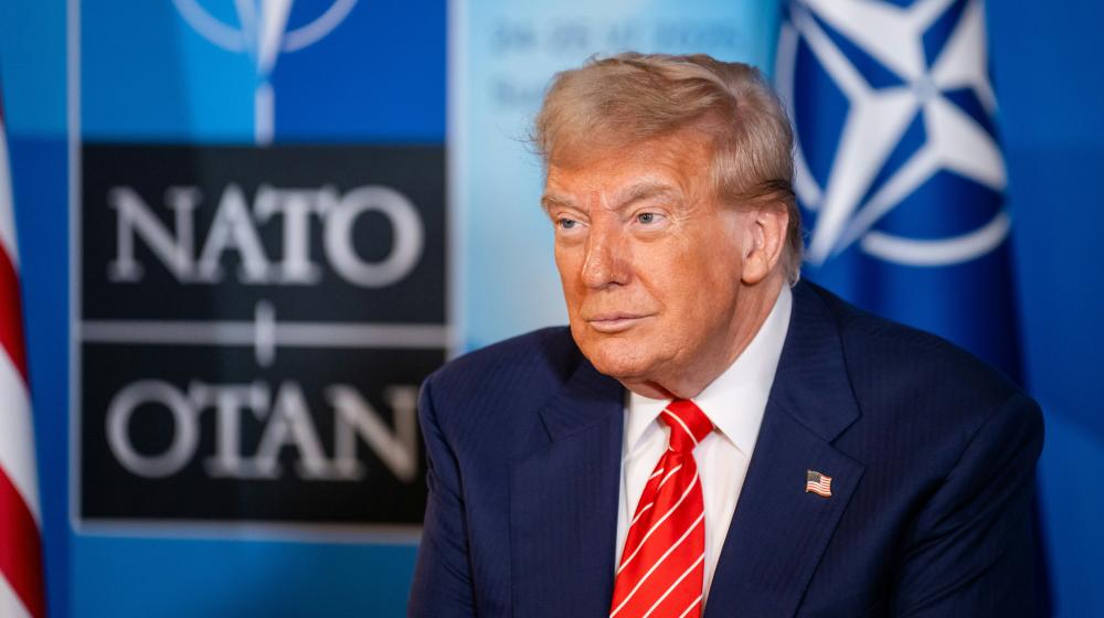 Donald Trump with NATO logo in the background. Credit photo: NATO