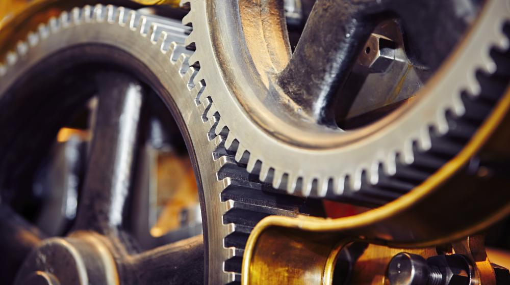 Extreme close-up of interlocking industrial gears. Image credit to Envato Elements.