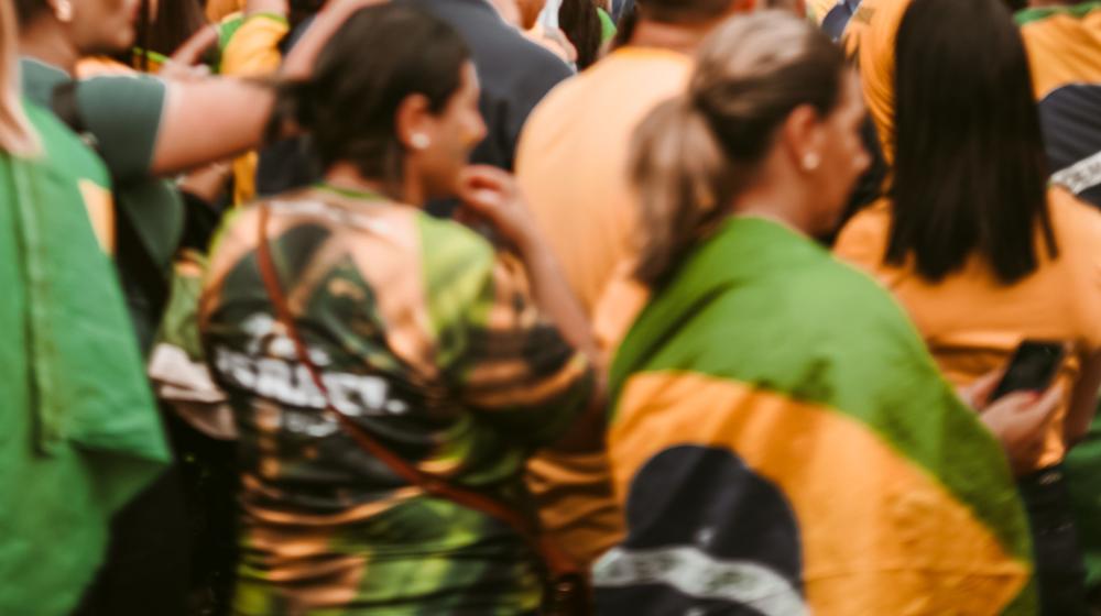A peaceful street demonstration in Brazil with people holding national flags. Image credit to Geancarlo Peruzzolo on Pexels.