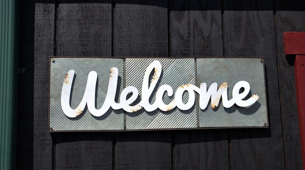 Board with "Welcome" written on it. Photo by Katherine Hood on Unsplash 